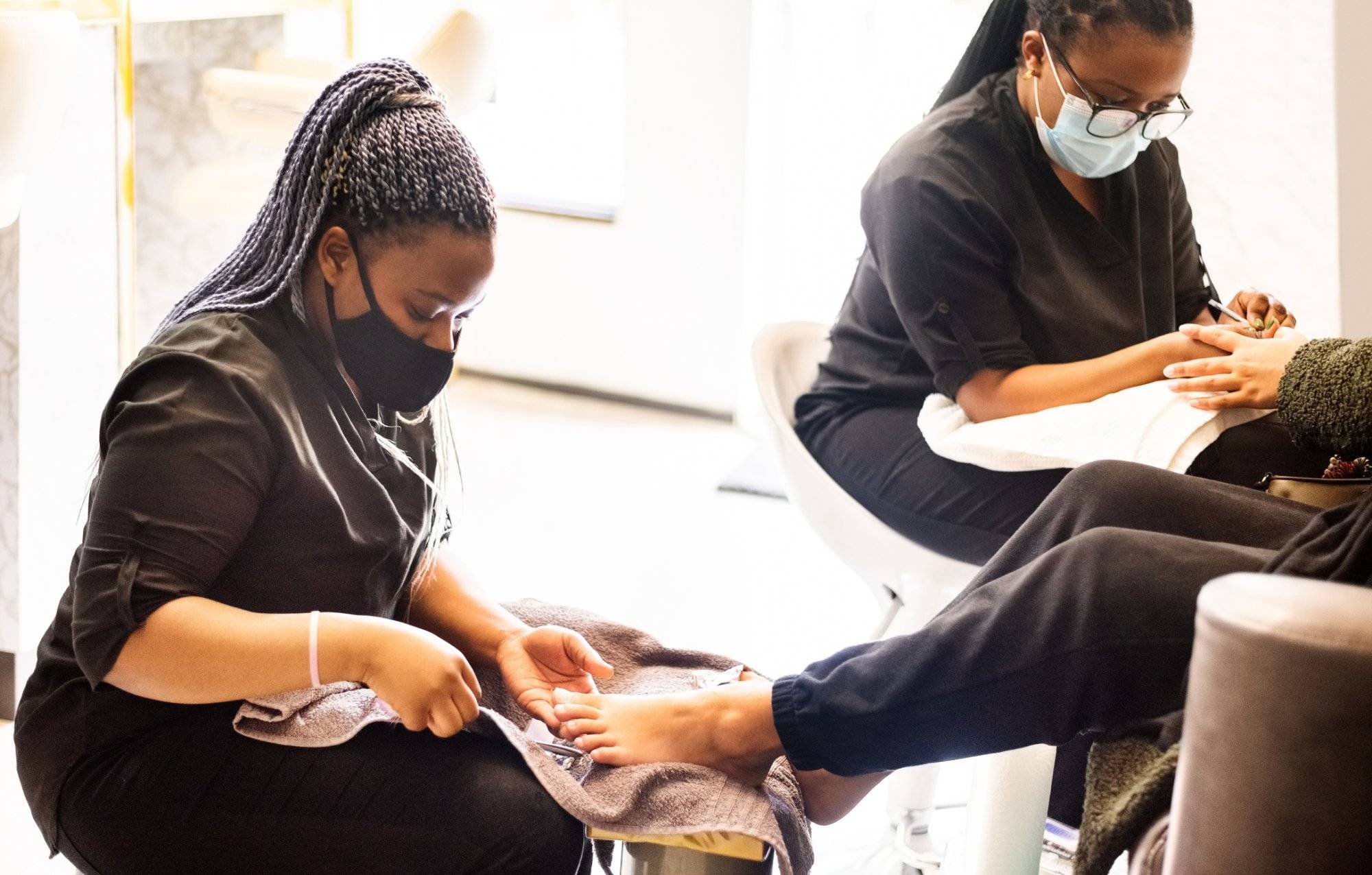 Woman having pedicure and manicure at beauty spa during pandemic Woman having pedicure and manicure at beauty spa during pandemic