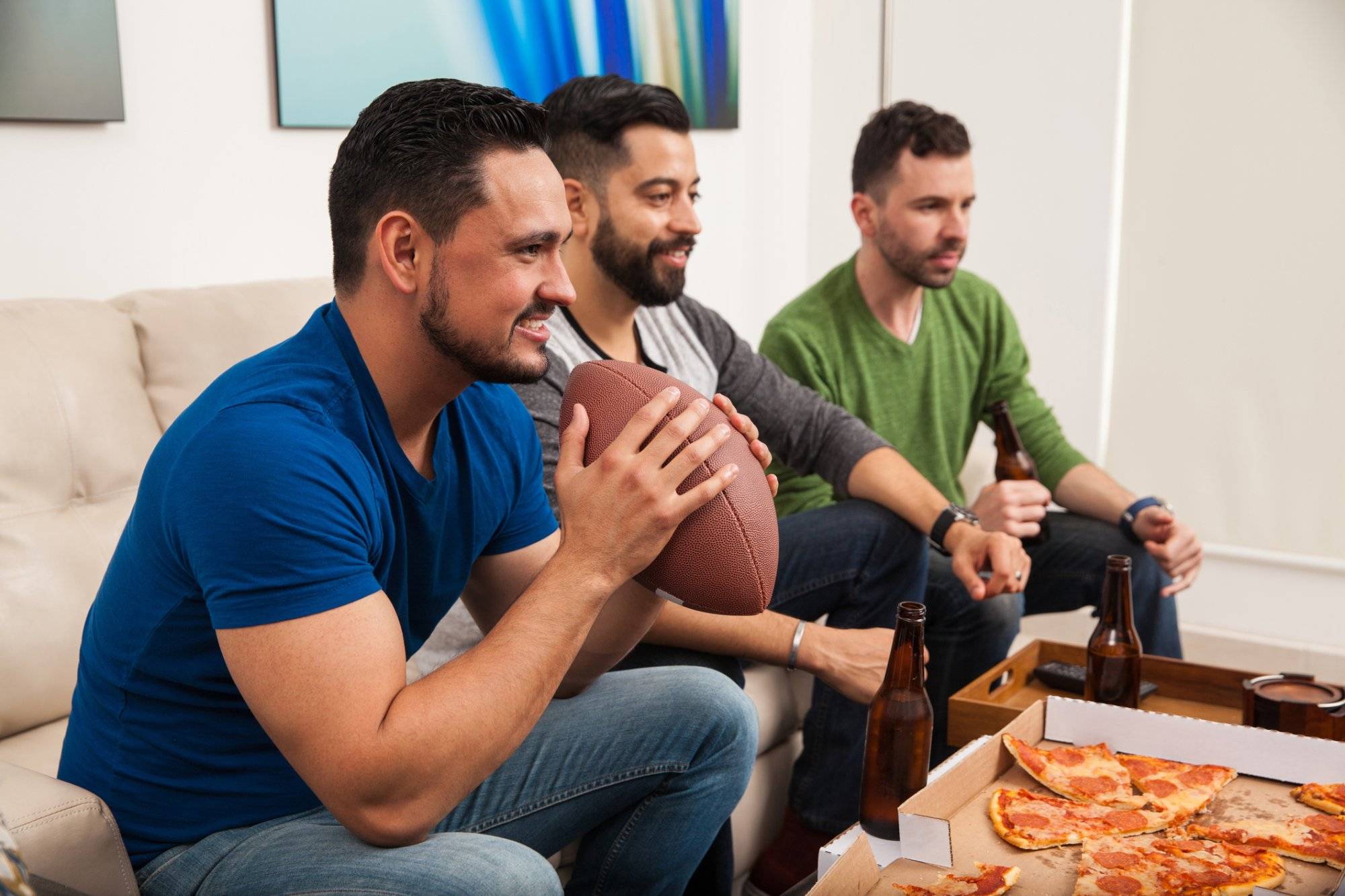 Young friends watching a football game Young friends watching a football game